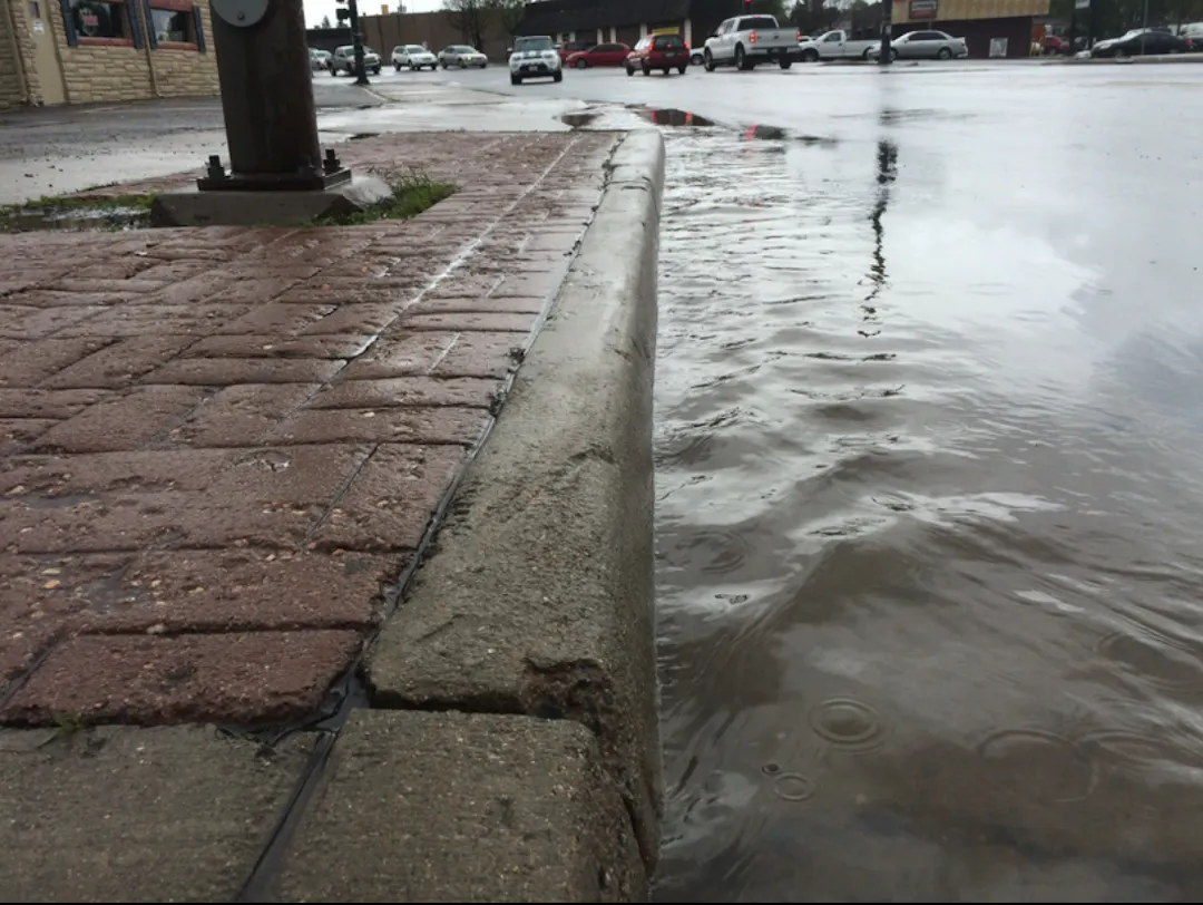 Stormwater flowing in a gutter.
