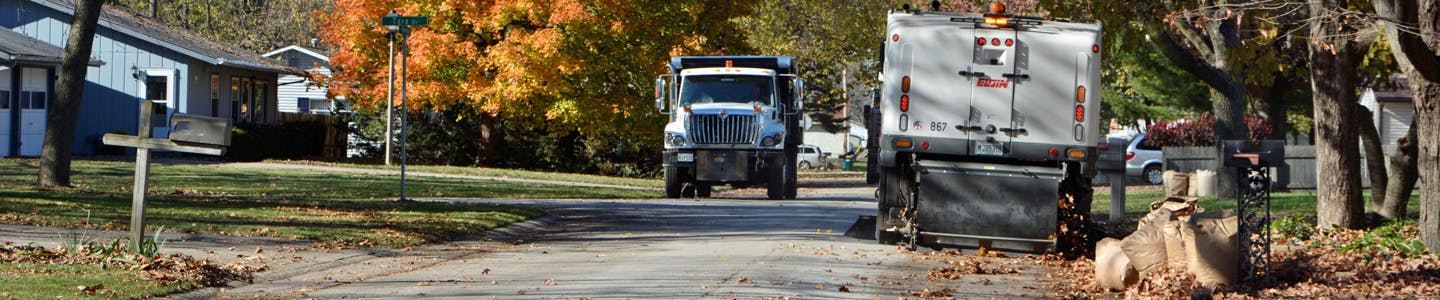 Fall street sweeping with two Public Works vehicles