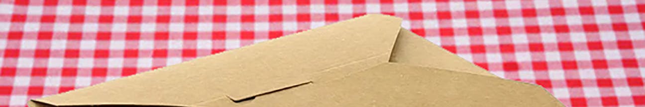 Cardboard to go box on a red checked tablecloth