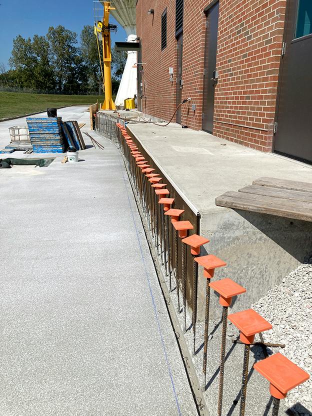 Rebar lines the way along the sidewalk in front of the Chemical Building where a retaining wall will be poured. The walkway will also be completed.