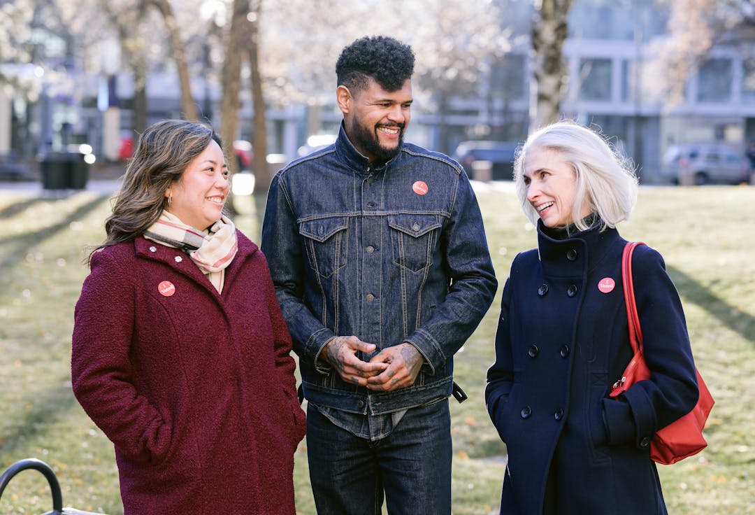 Smiling person wearing "I Voted" sticker