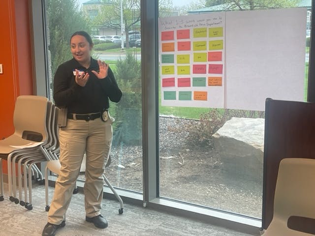 Facilitator addresses participants during a cardstorming listening session