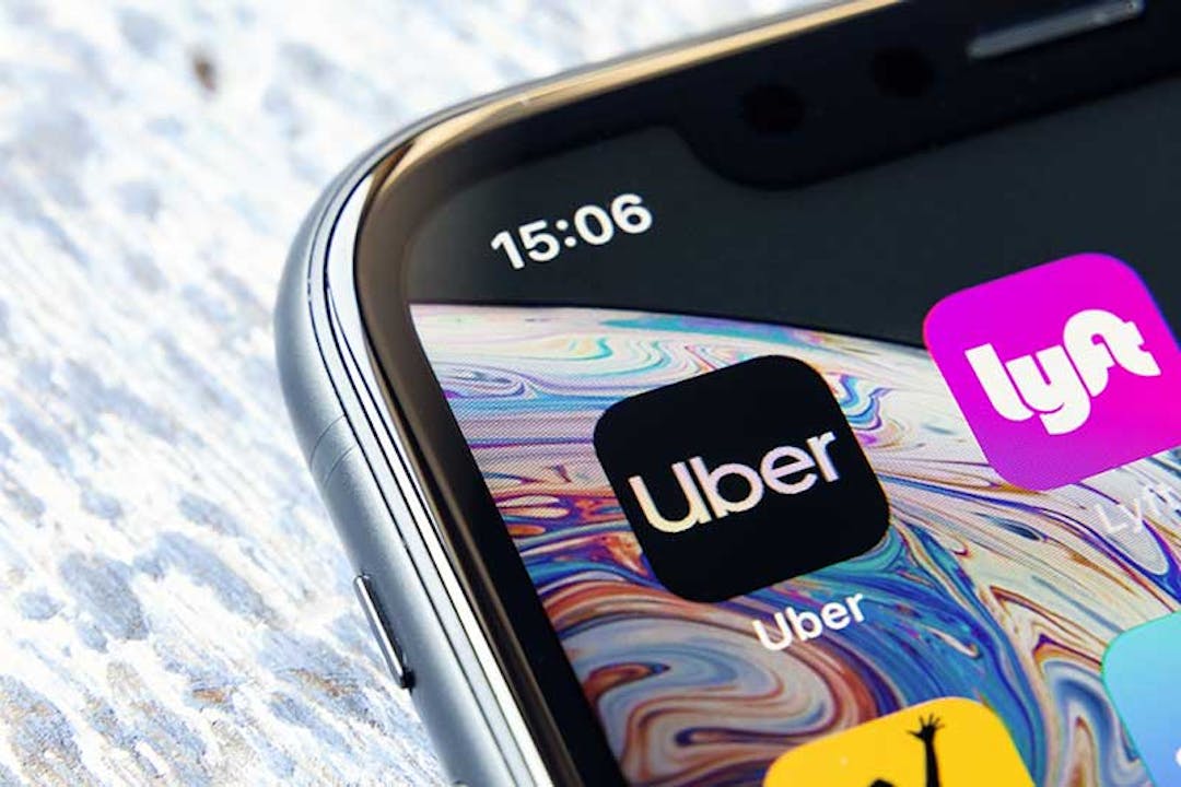 Image of a cell phone with an Uber and a Lyft app