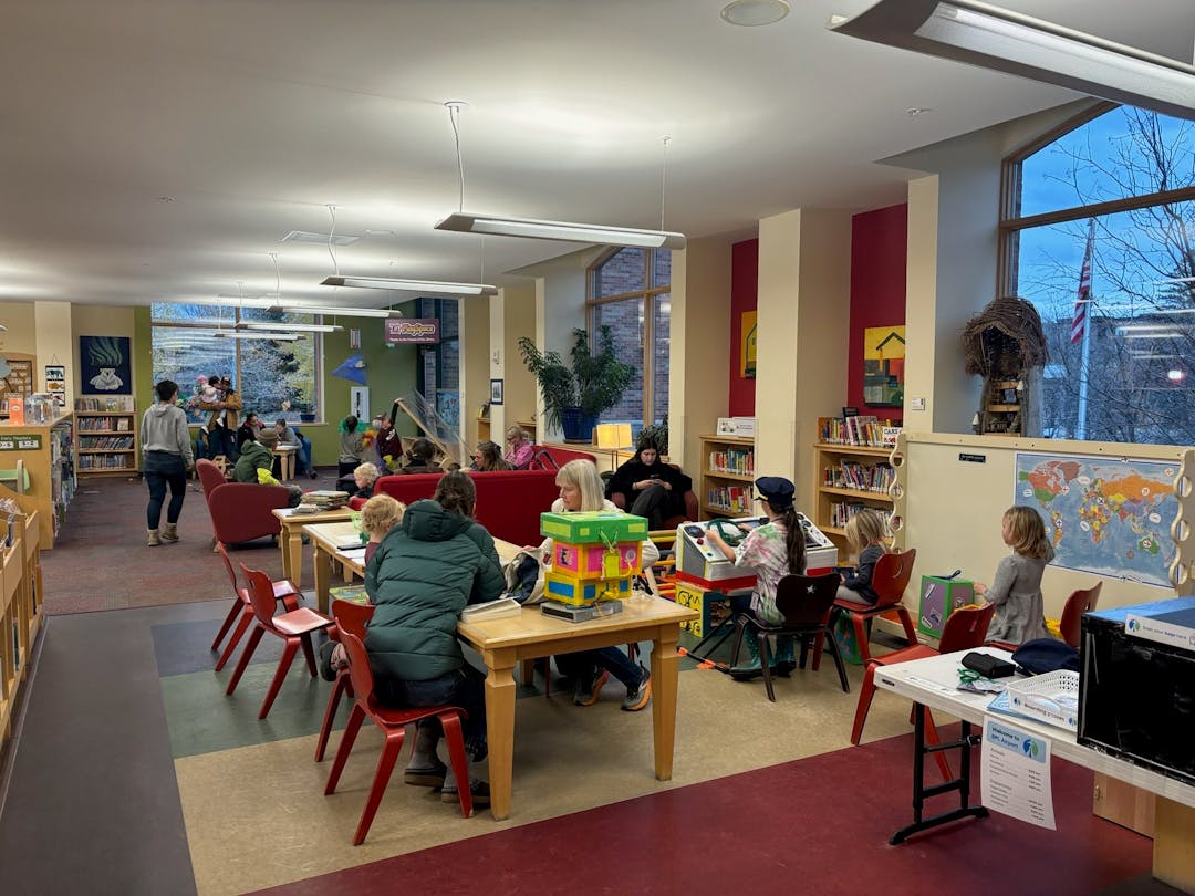 Children and adults read and play in the Children's Room of the Bozeman Public Library.