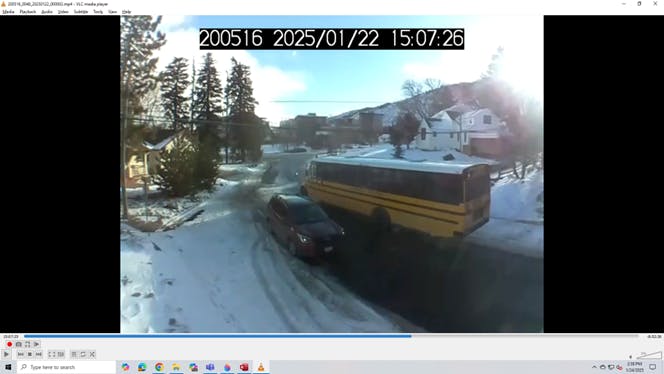 Car and a school bus pass successfully in the narrowest part of the Pinal road following sidewalk construction.