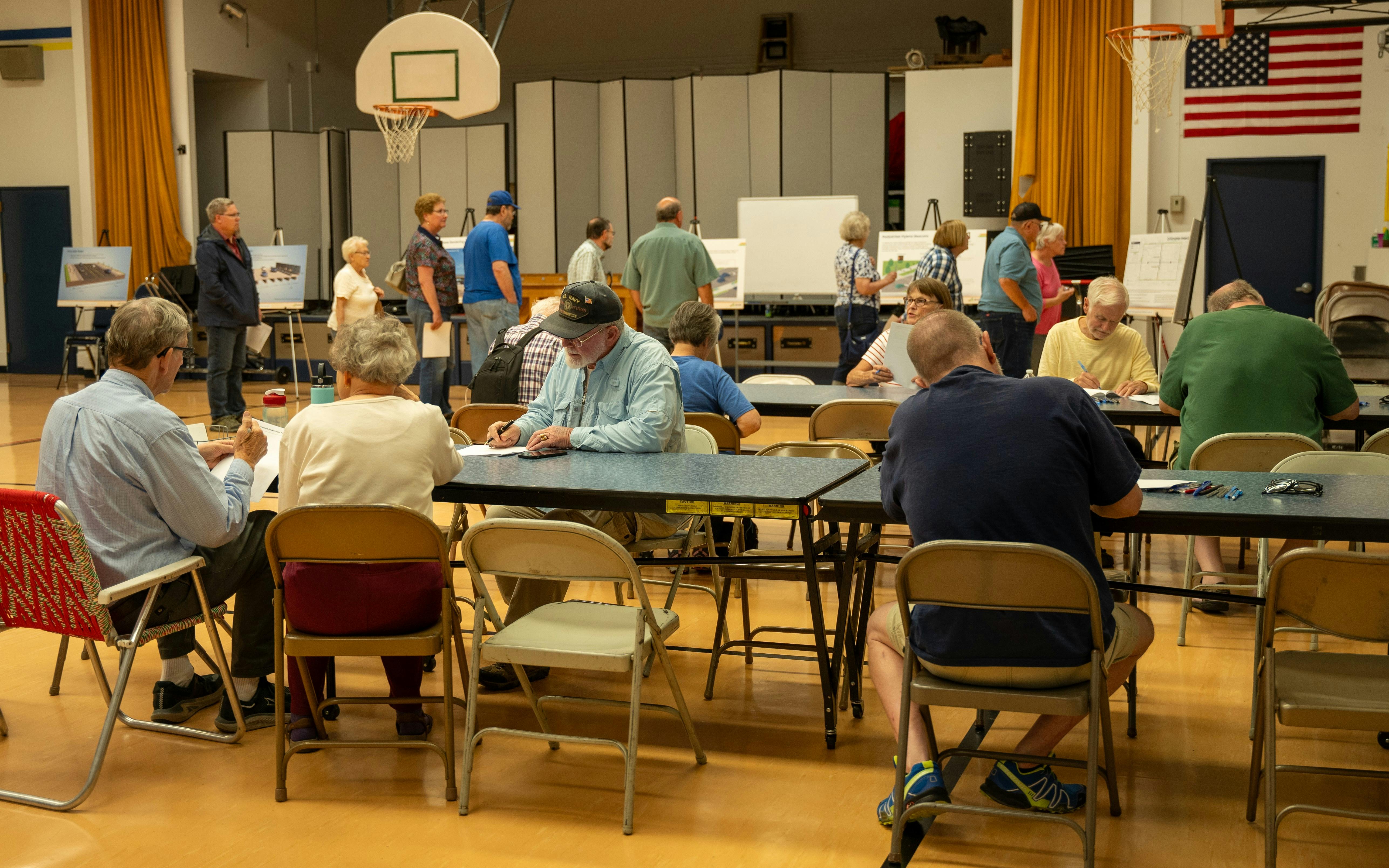 People sitting at table filling out comment sheets.