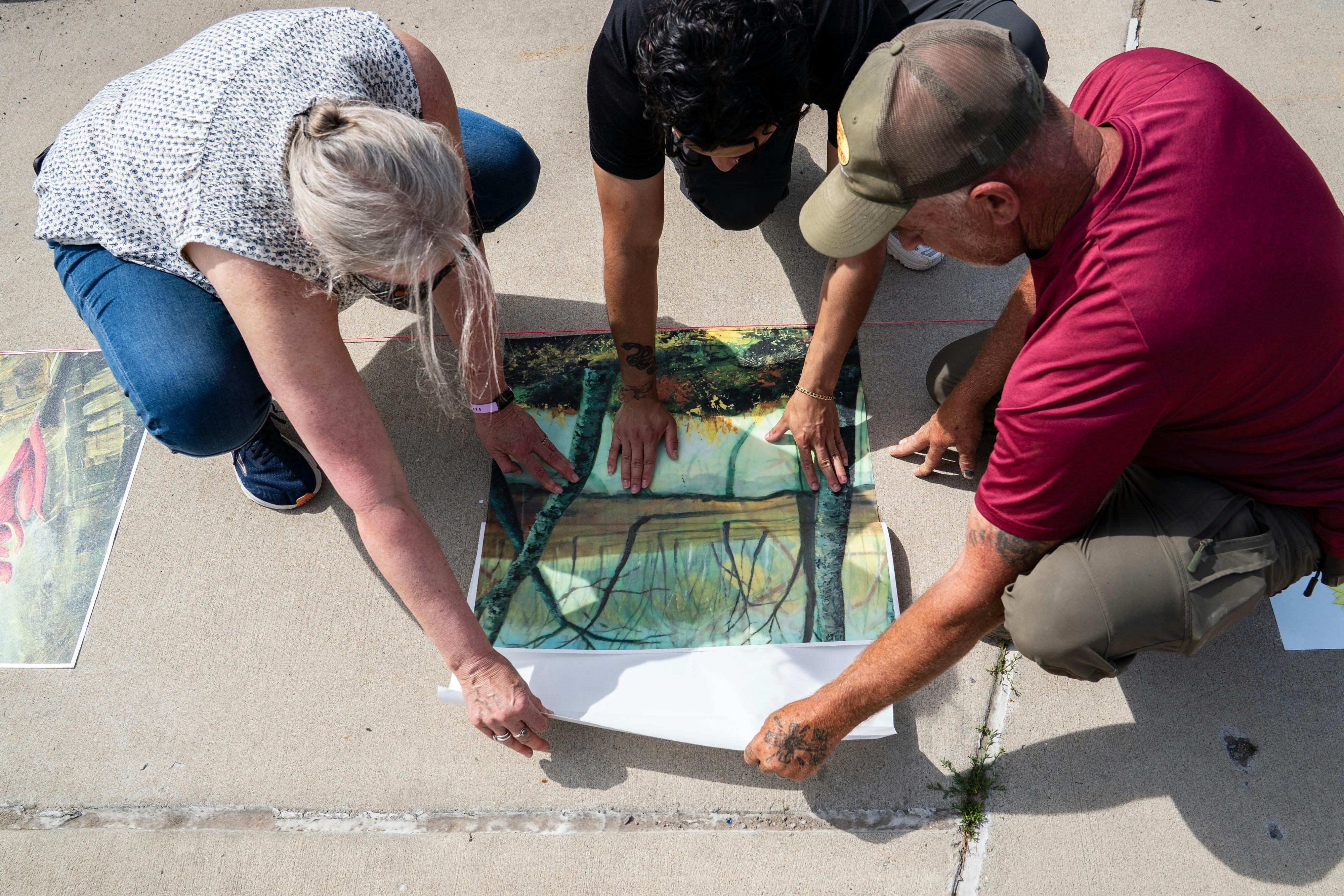 Town Staff and Contributing Artist install Artwork Along Pollinator Pathway