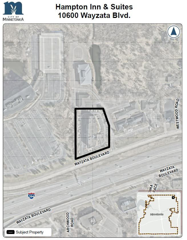 A map showing the outlined Hampton Inn & Suites property at 10600 Wayzata Blvd, located north of I‑394 along Wayzata Boulevard, with nearby roads and buildings visible.