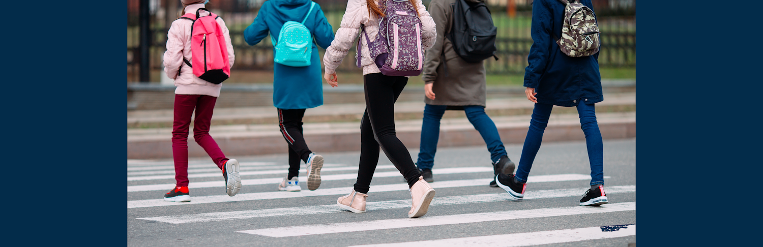 People cross the street in a crosswalk