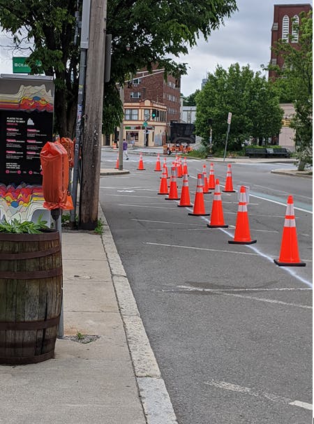 Shared curbs pilot with bagged meters, quick-build extended sidewalk and short-term parallel parking