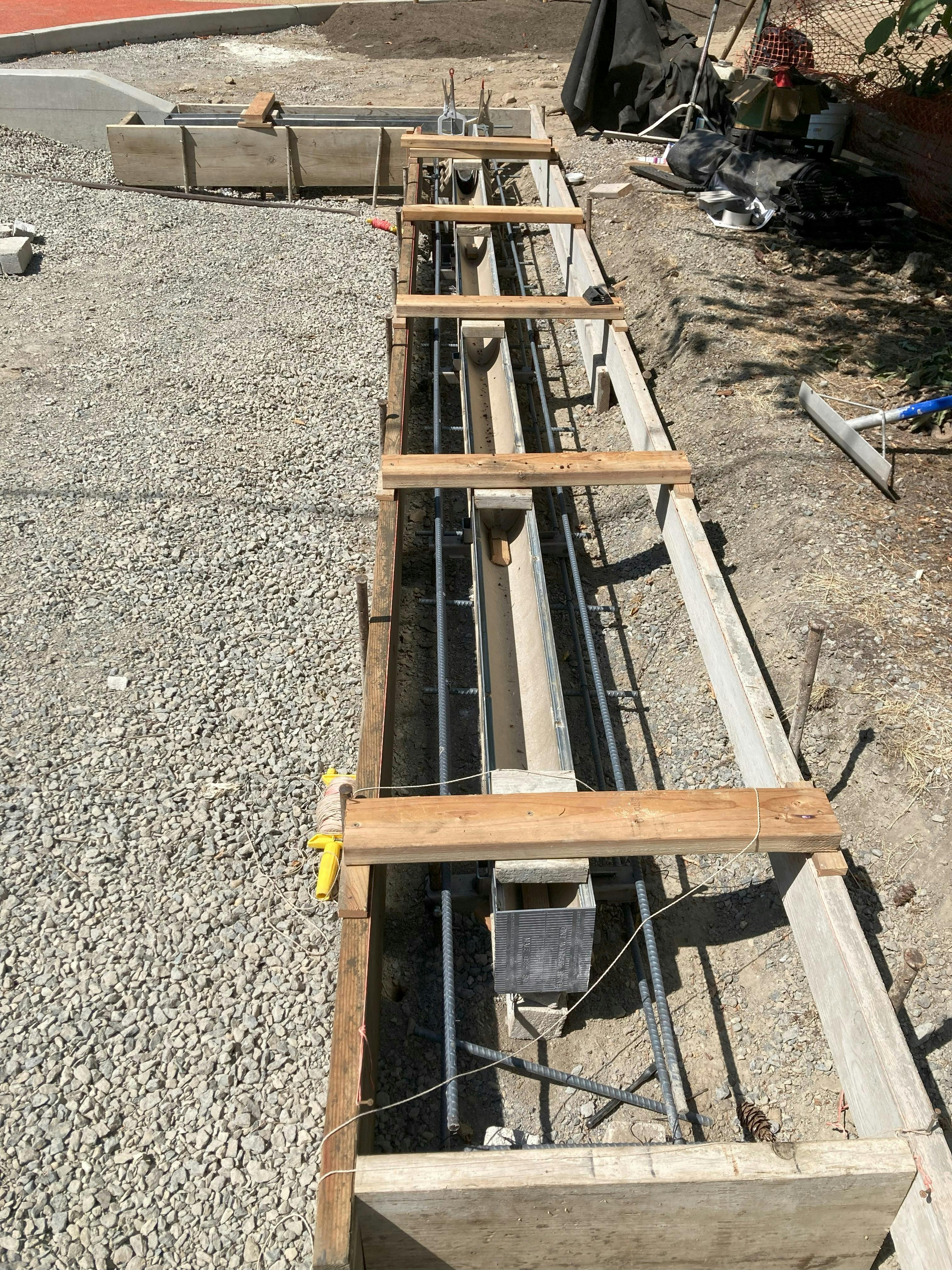 Concrete form for parking area trench drain