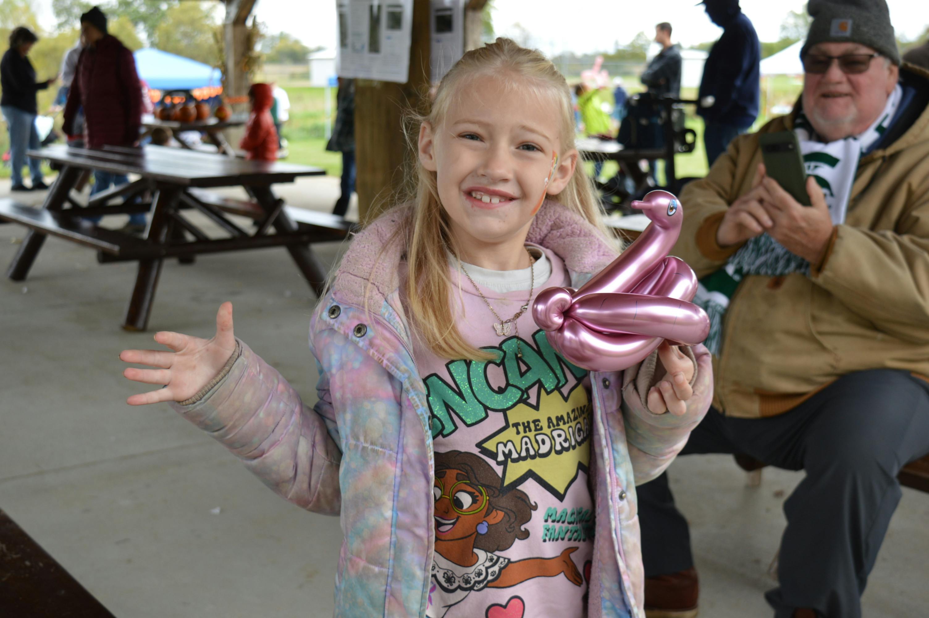 Young guest's big smiles as she shows off her balloon swan!