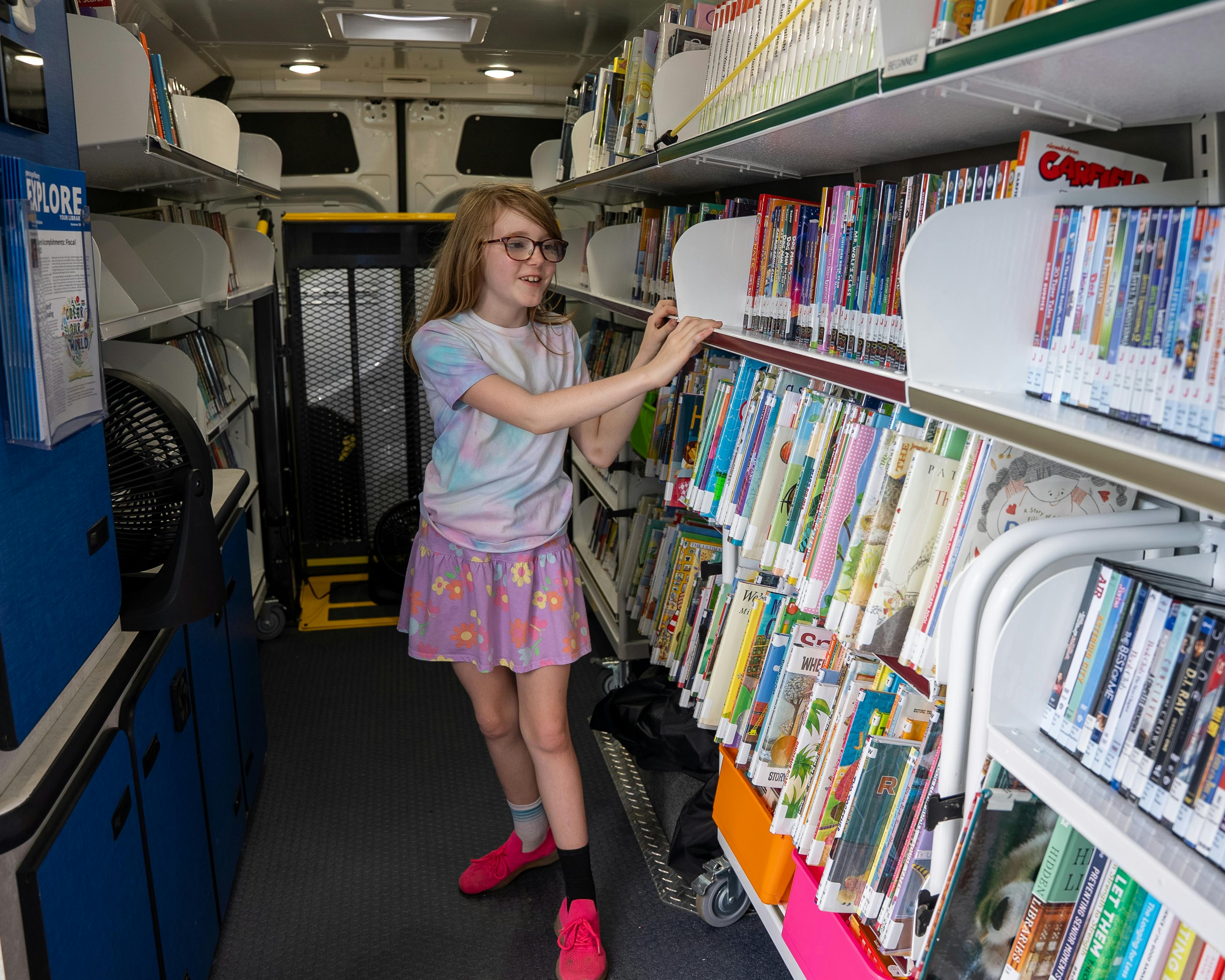 Child inside Prince William Public Libraries mobile library van