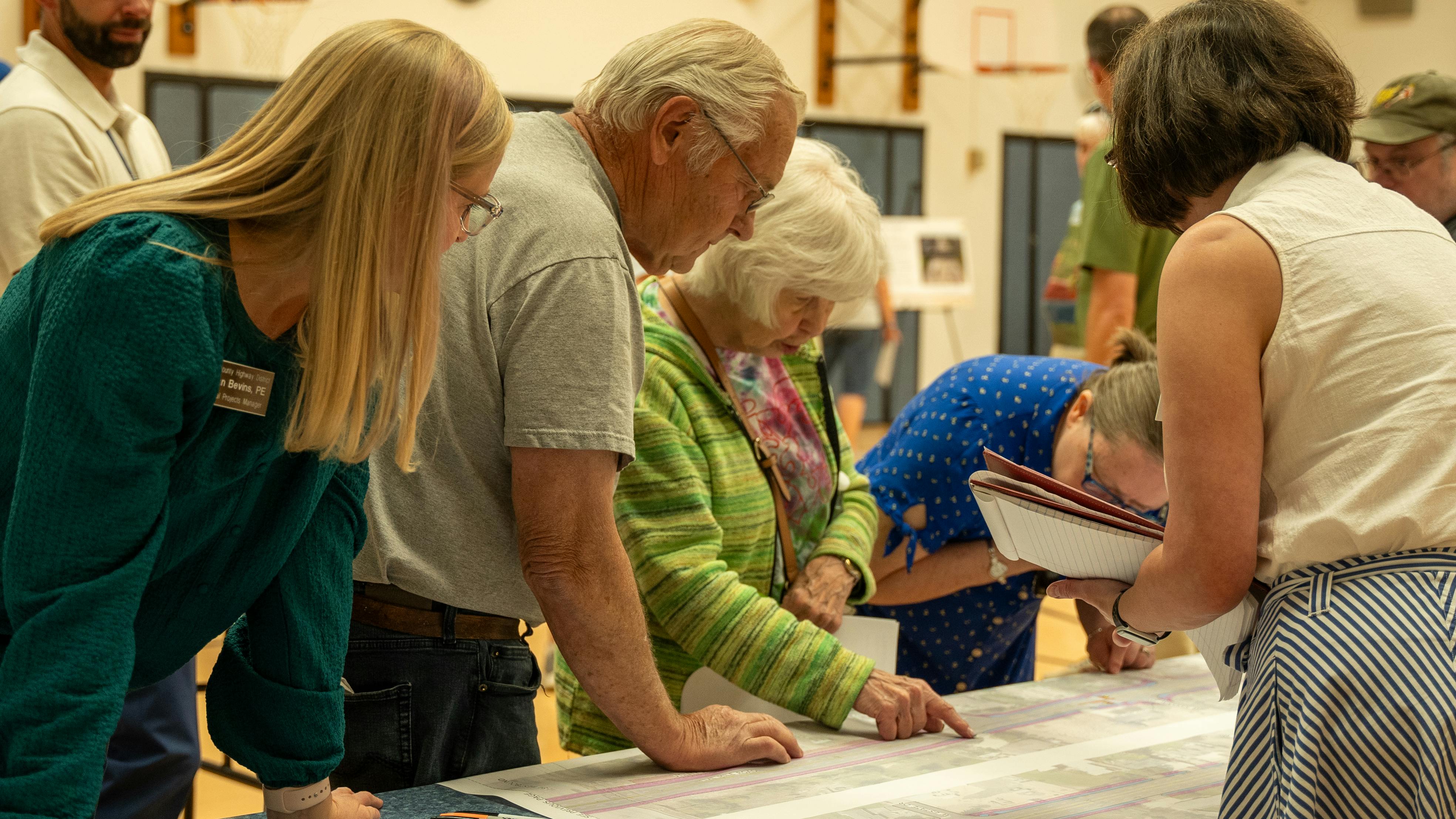 People looking at roadway plans