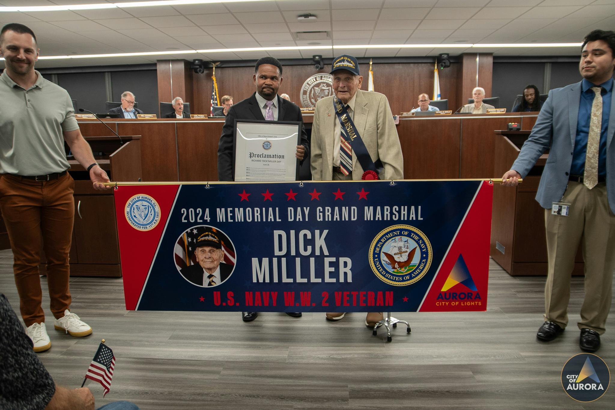 Mayor Richard C. Irvin and Dick Miller pose behind the Memorial Day Parade Grand Marshal banner.