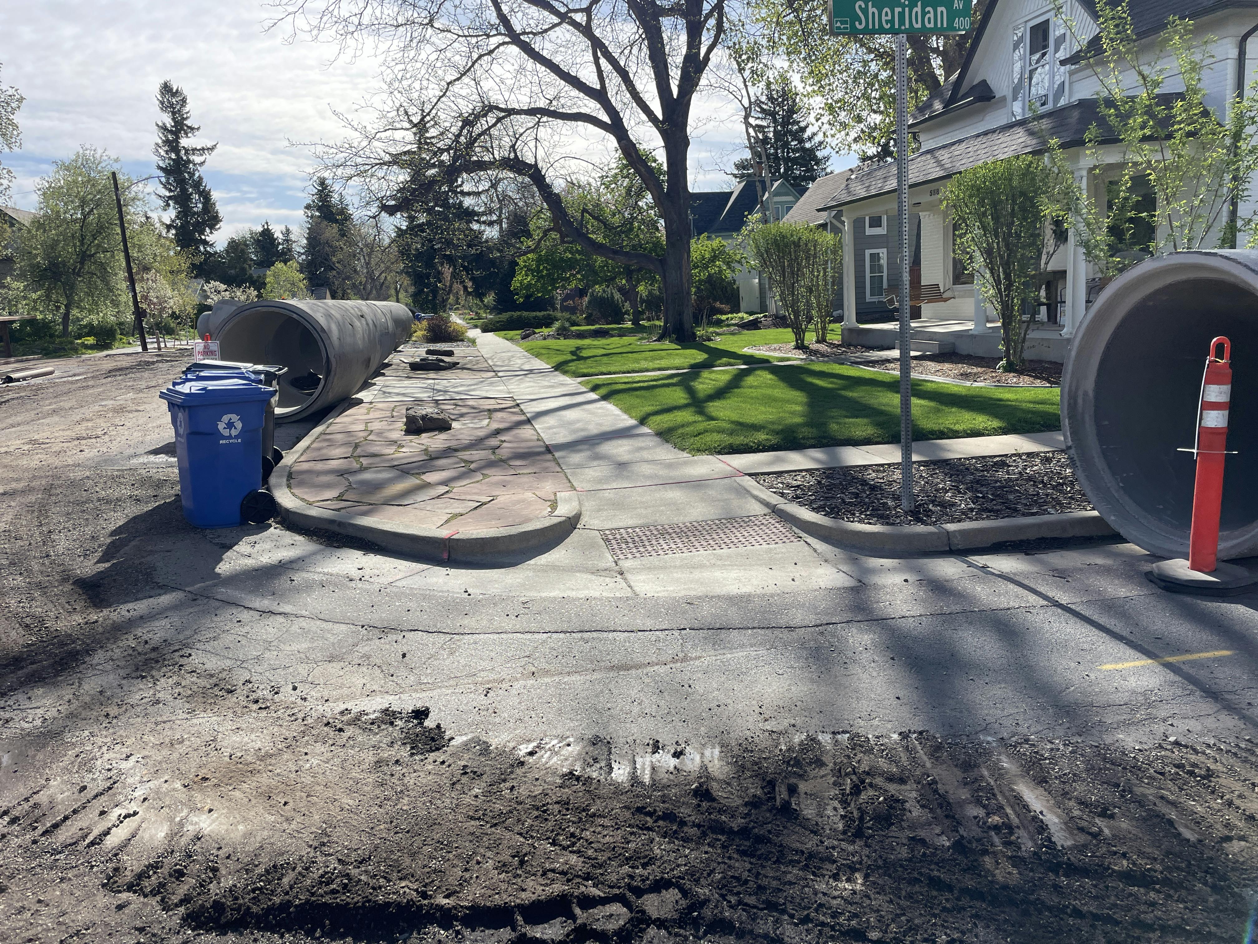At the corner of 5th Street and Sheridan Avenue, large, 54-inch-diameter pipe segments are staged for the upcoming placement.