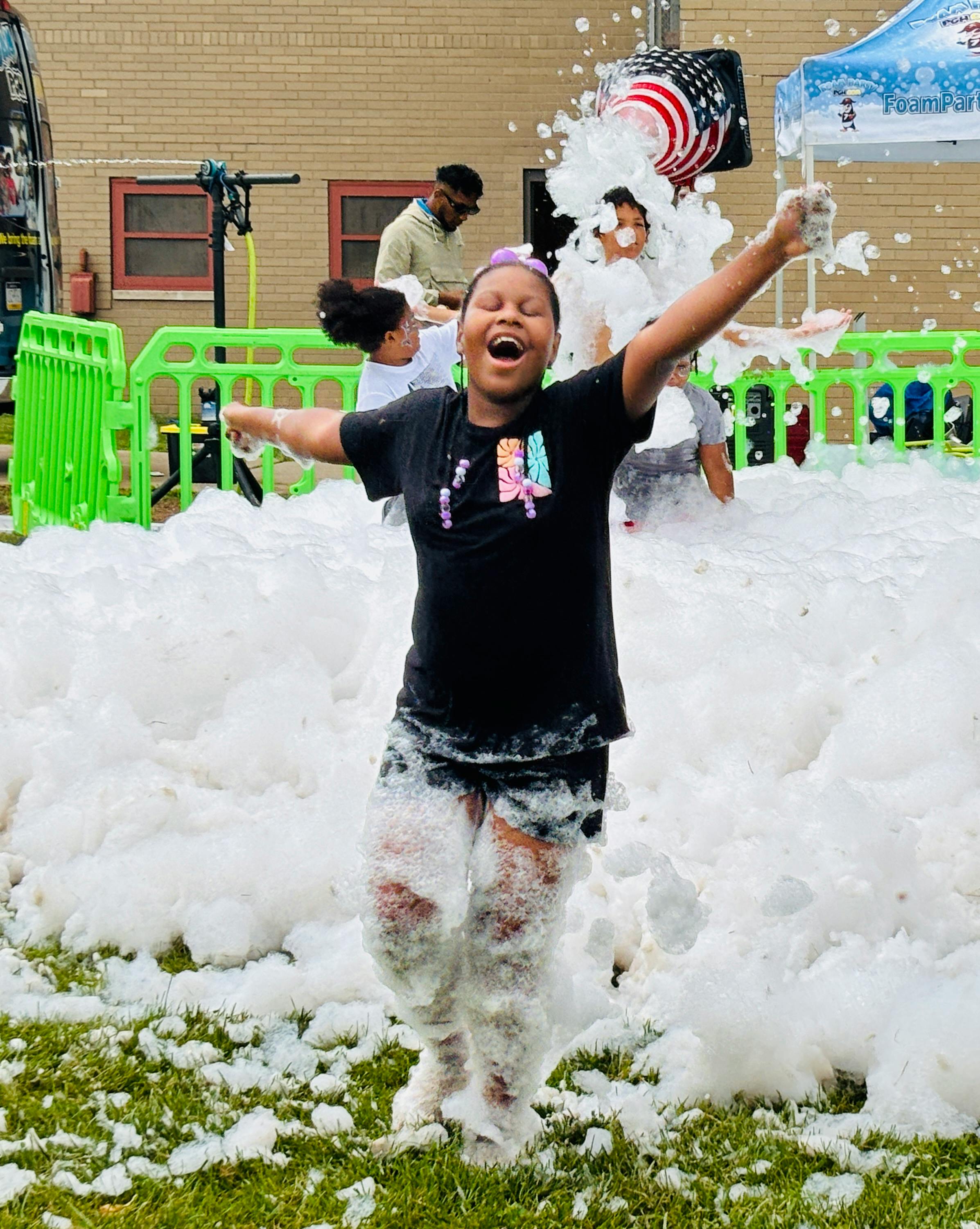 Children enjoy the foam machine by Foam Party Pittsburgh at a Northview Heights Community Day.