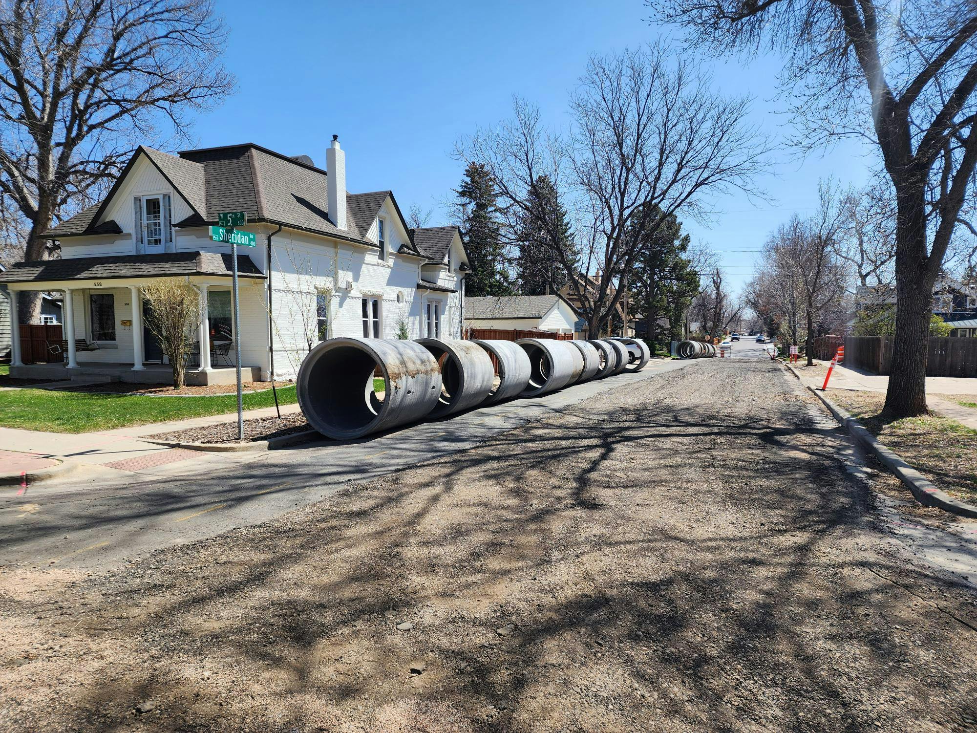 The storm sewer segments are large and heavy as they are lined up for installation.