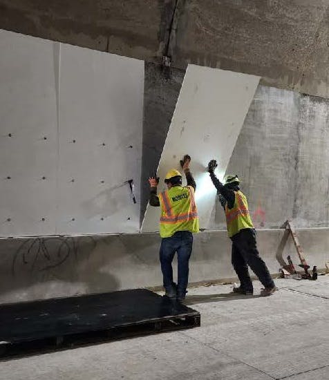 Crew installs new fireproof panels in the inbound Armstrong Tunnel