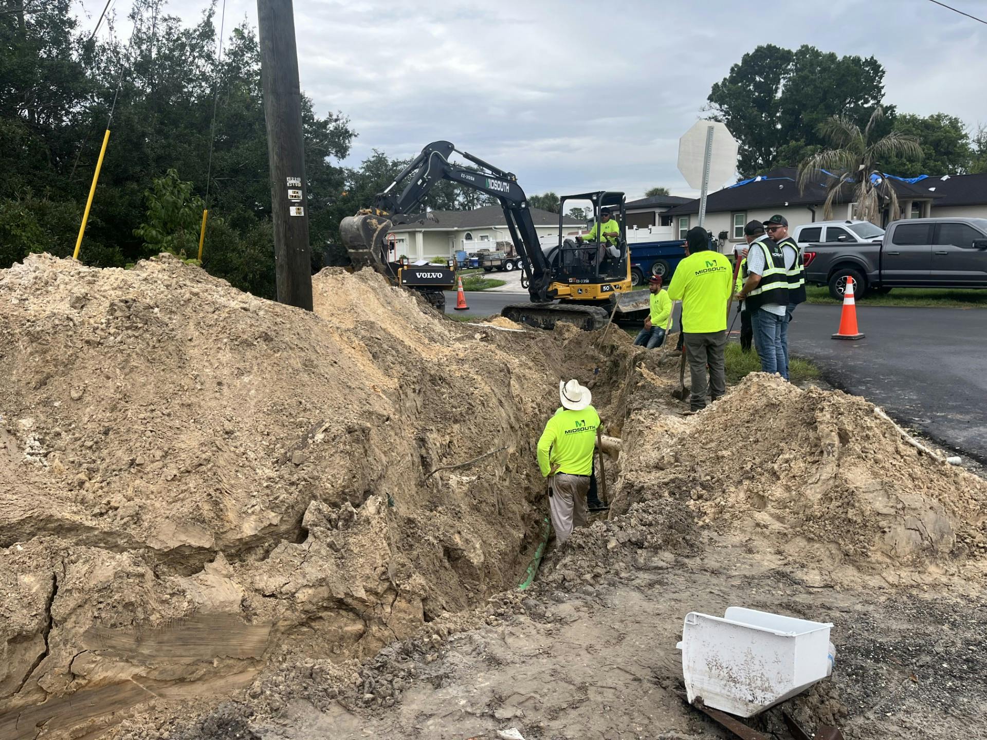 people digging on side of the road