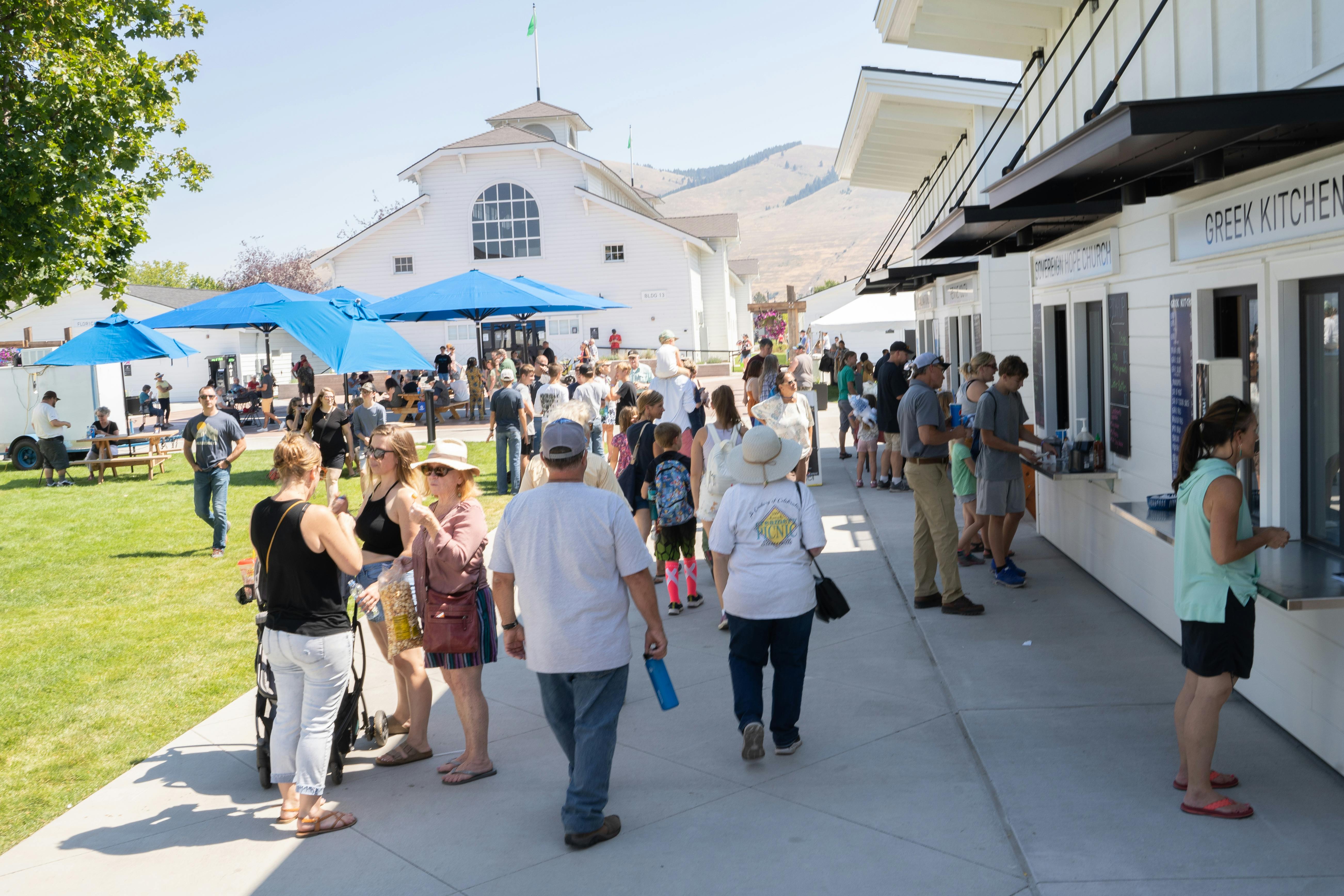 People standing in line for concessions on a sunny day at the Fair.