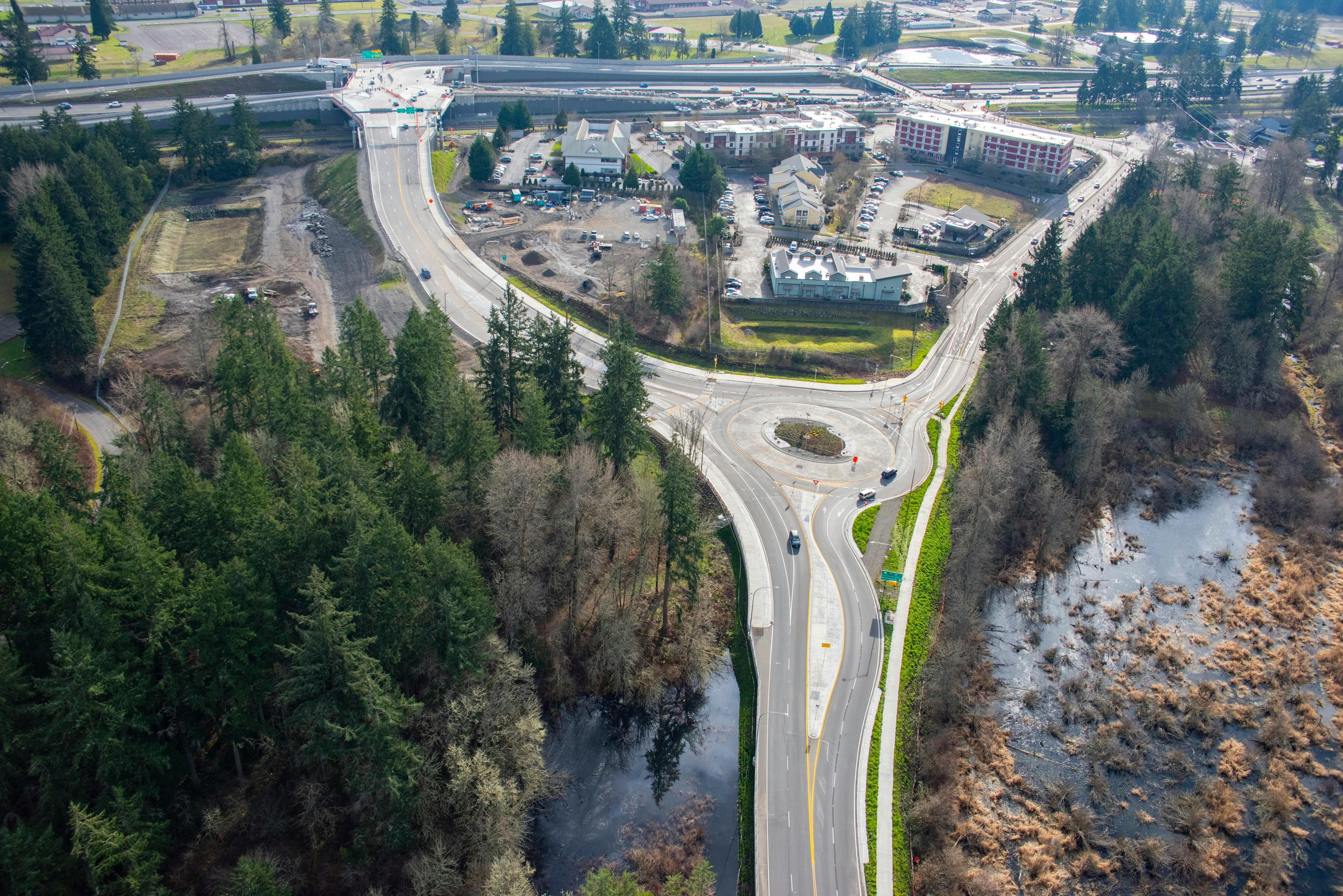 An aerial view of a new roundabout connecting to two bridges over I-5.