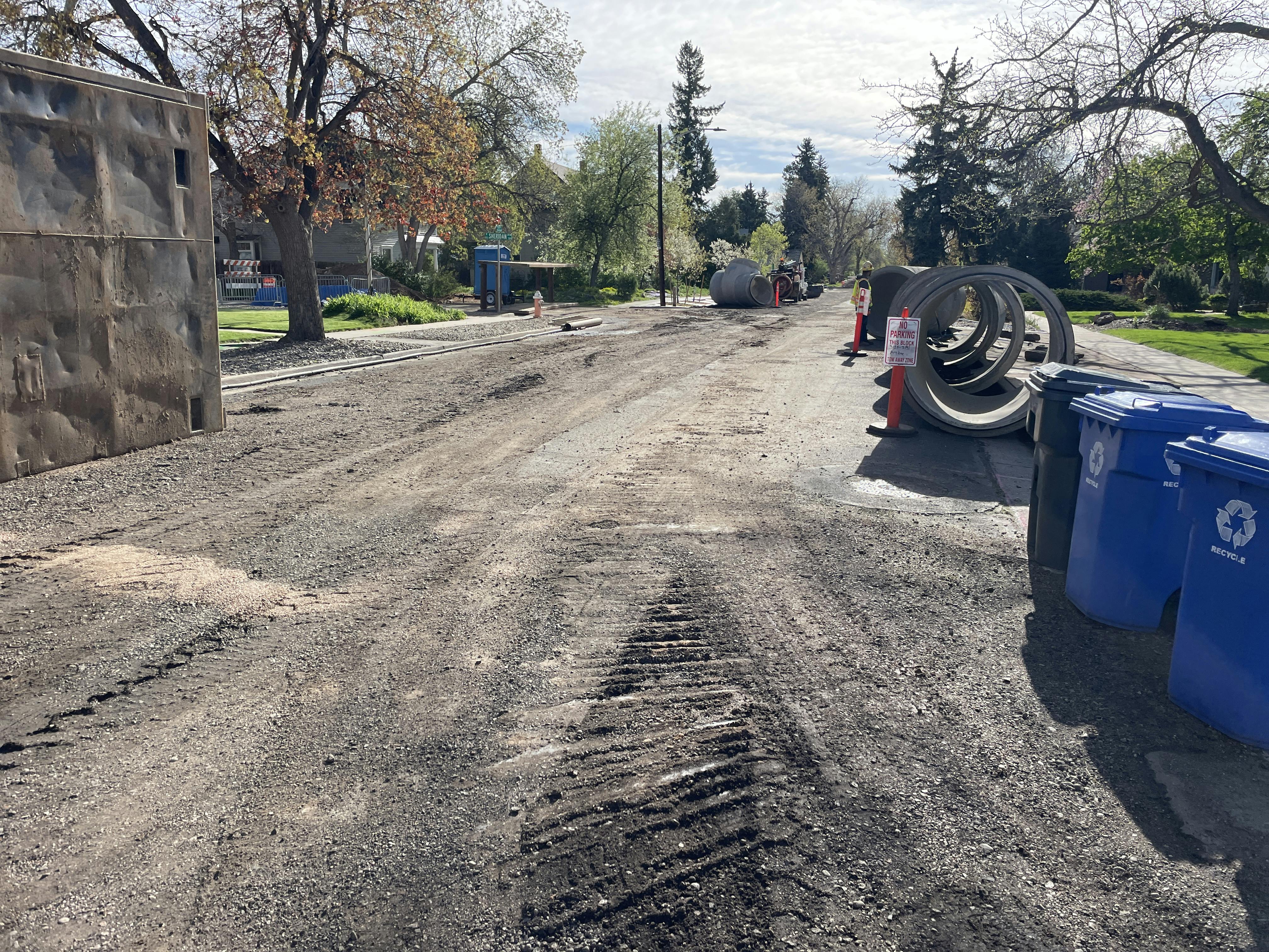 Looking down 5th Street, you can see the carlsonator pipe segment (looks like a t-joint) and to the left of the photo is the wall stabilizer that is used to prevent soil from collapsing in the work area as workers lay the pipe segments.
