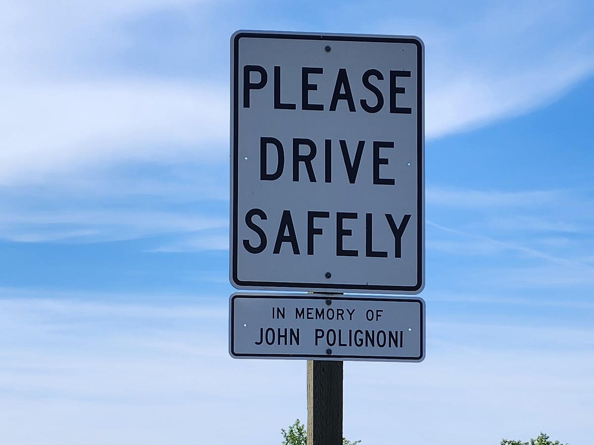 A sign reading "Please drive safely"