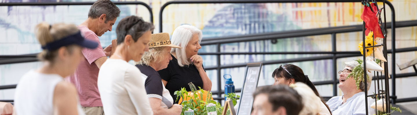 People talk to contractors and vendors during a programming event at the Superior Community Center