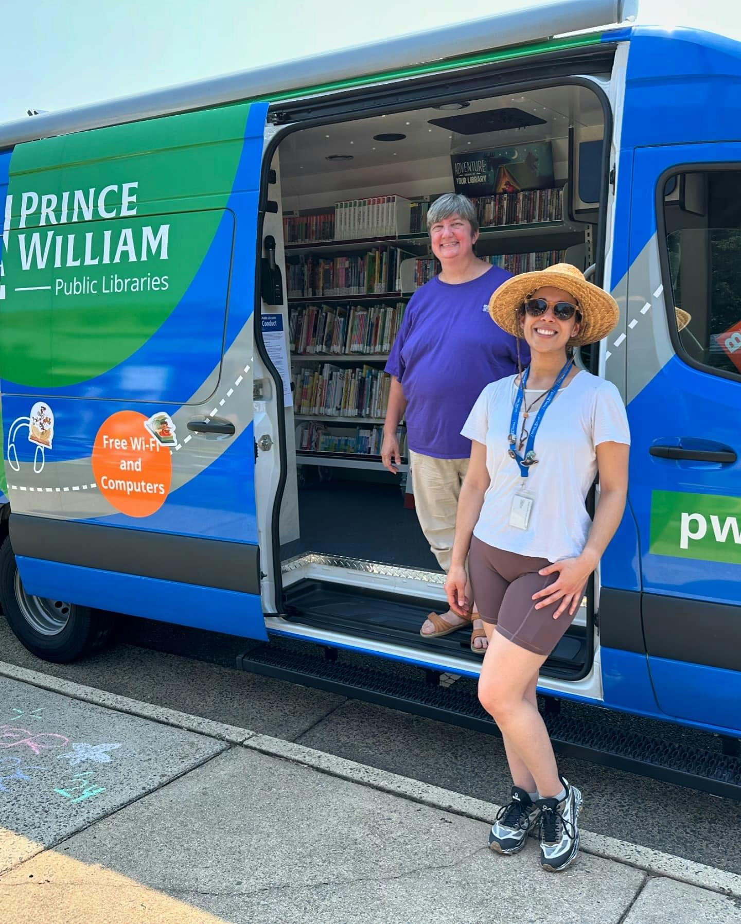 Staff standing by Prince William Public Libraries mobile library van