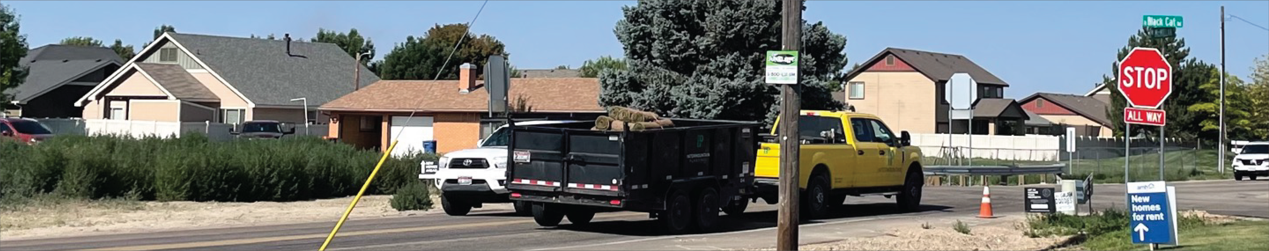 McMillan and Black Cat Intersection with truck pulling a trailer. 