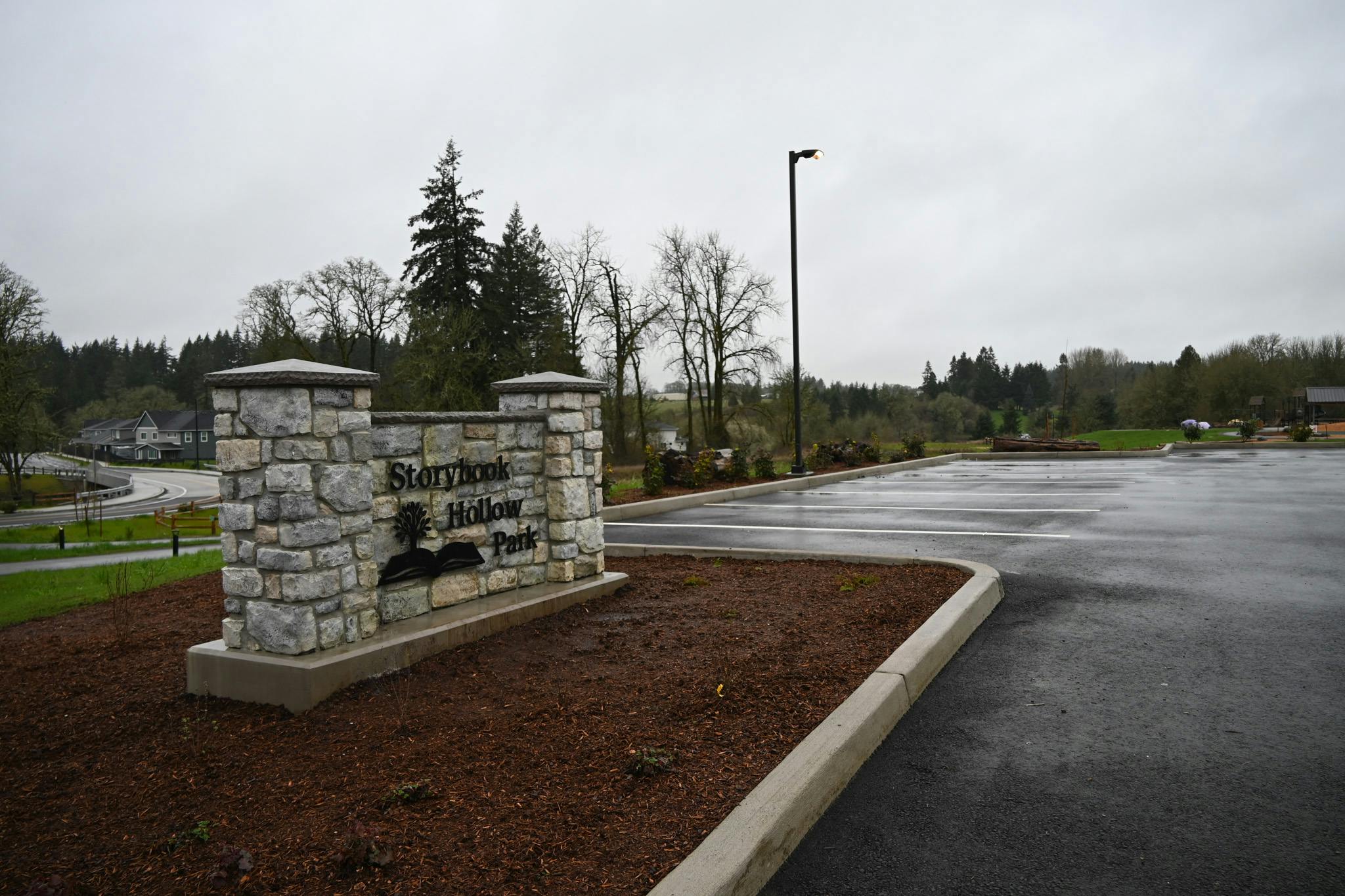 Park sign and parking lot at Storybook Hollow Park.