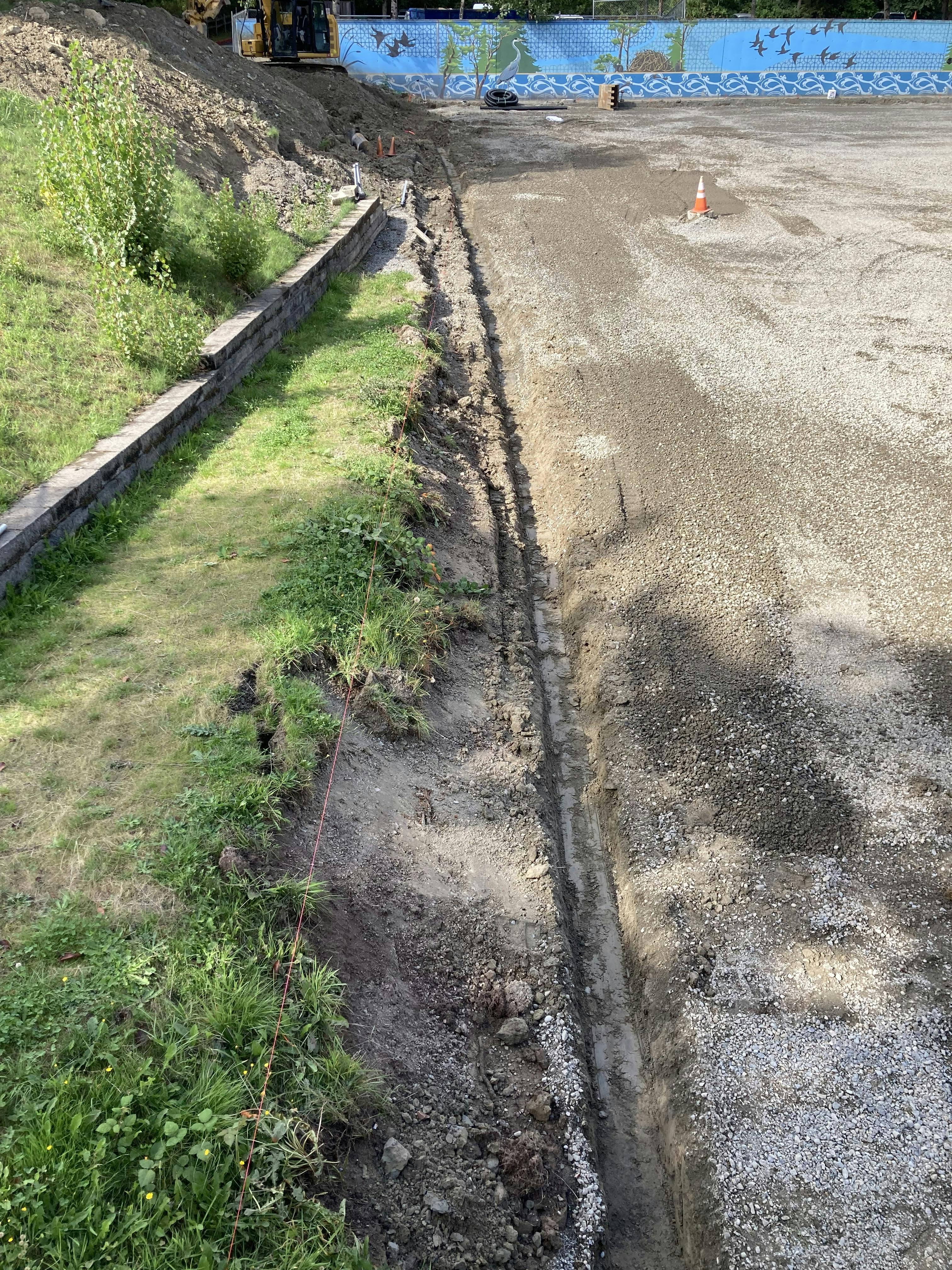 Trenching for a new drain pipe on the south edge