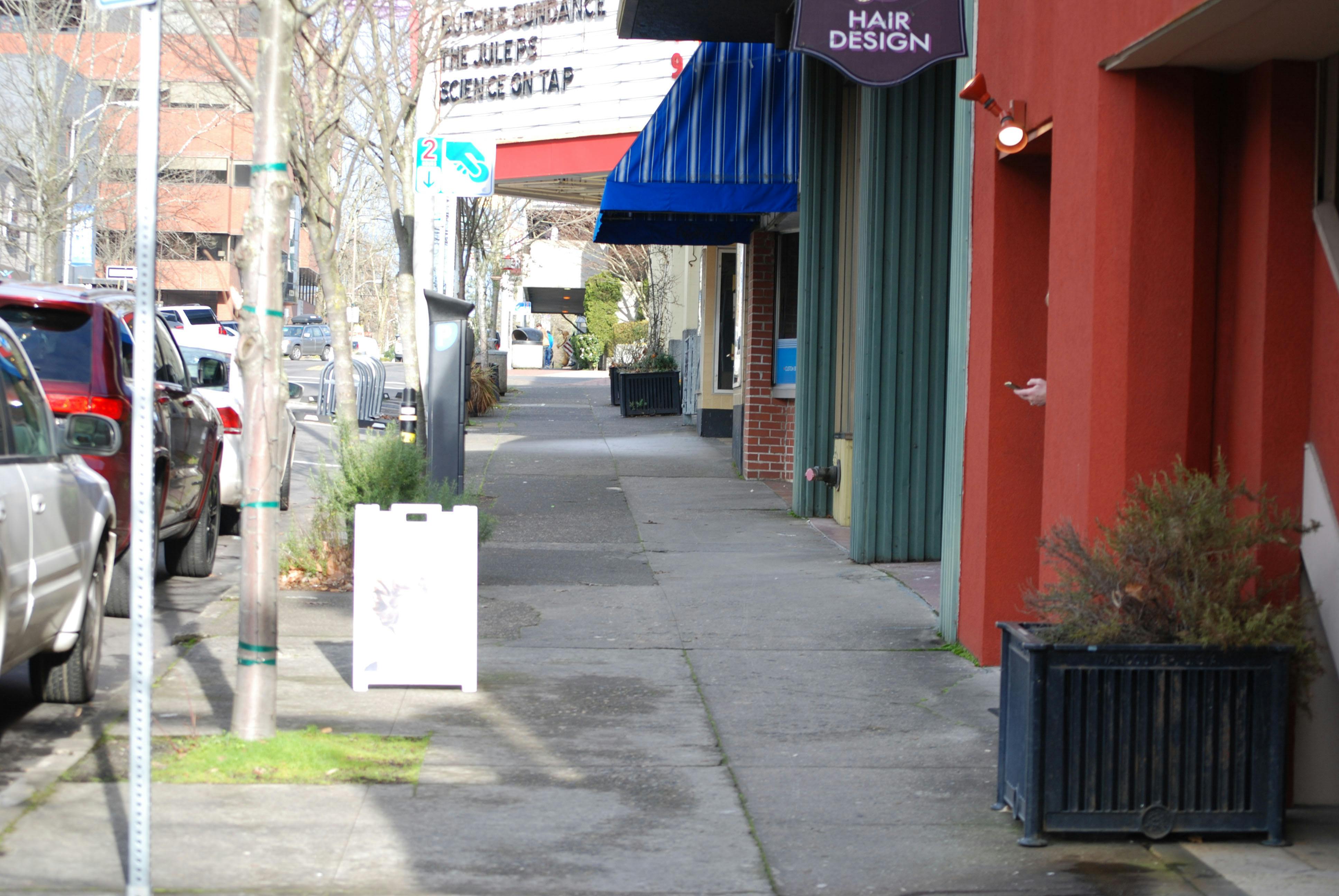 Planter and Sandwich Board Sign on Main