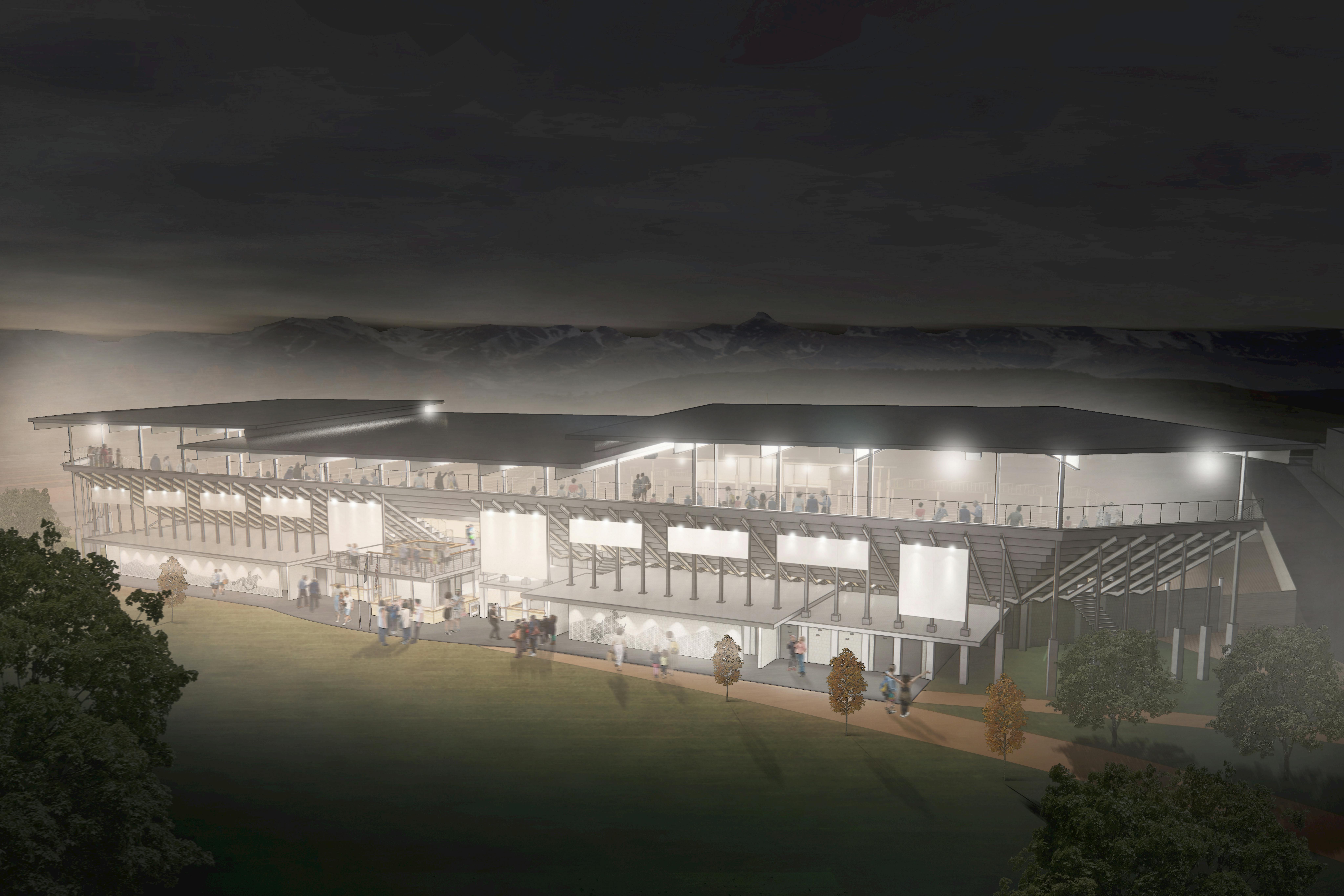 A rendering of the full rodeo arena building lit up at night.