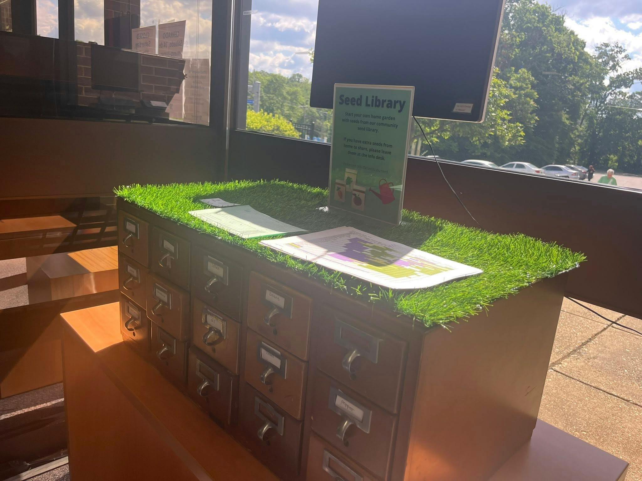 Library card catalog cabinet with seed library signs