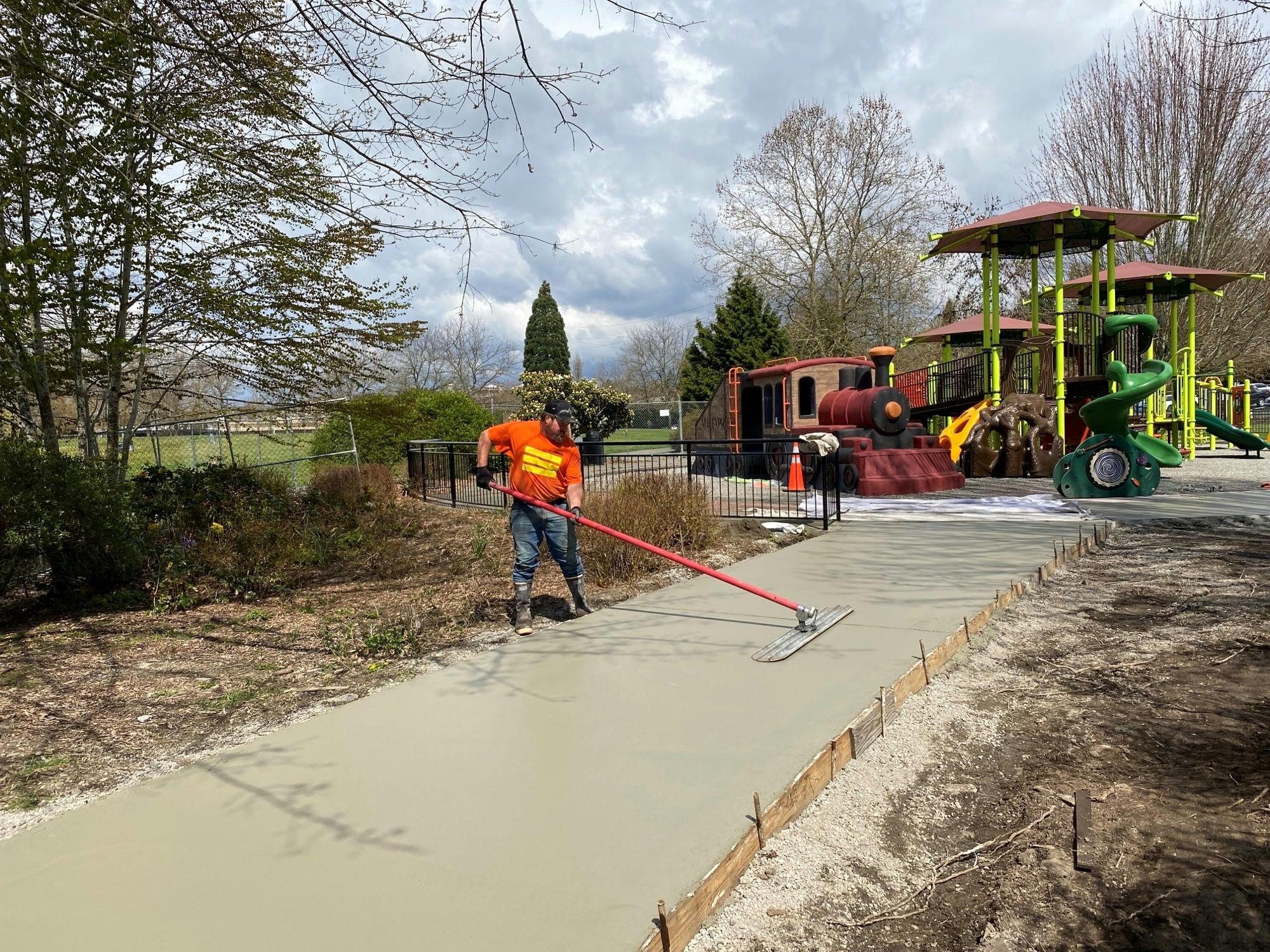 Concrete pathways poured and setting around the playground.