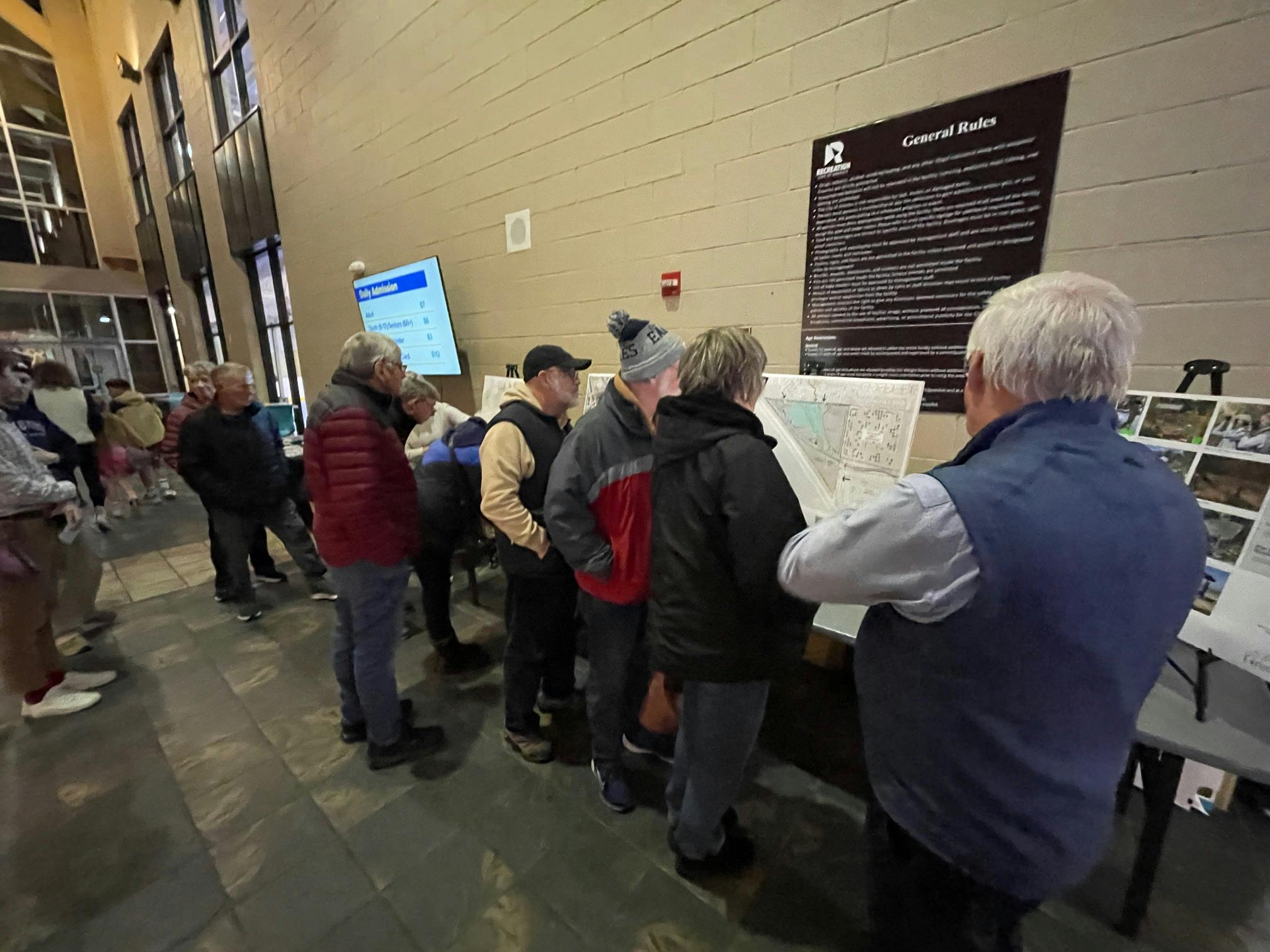A line of people looking at project boards.JPG