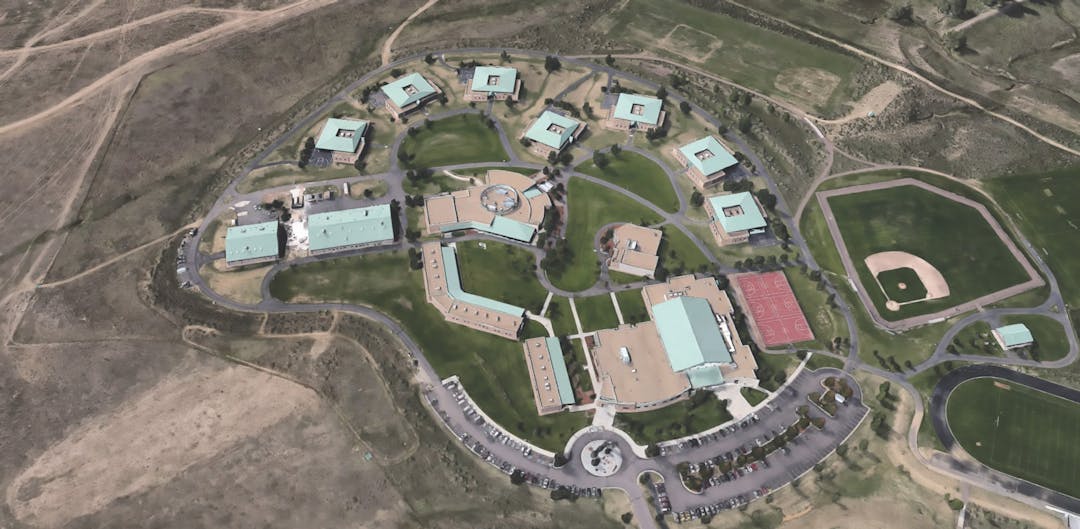 Aerial view of Ridge View campus showing several buildings parking lot, and open land