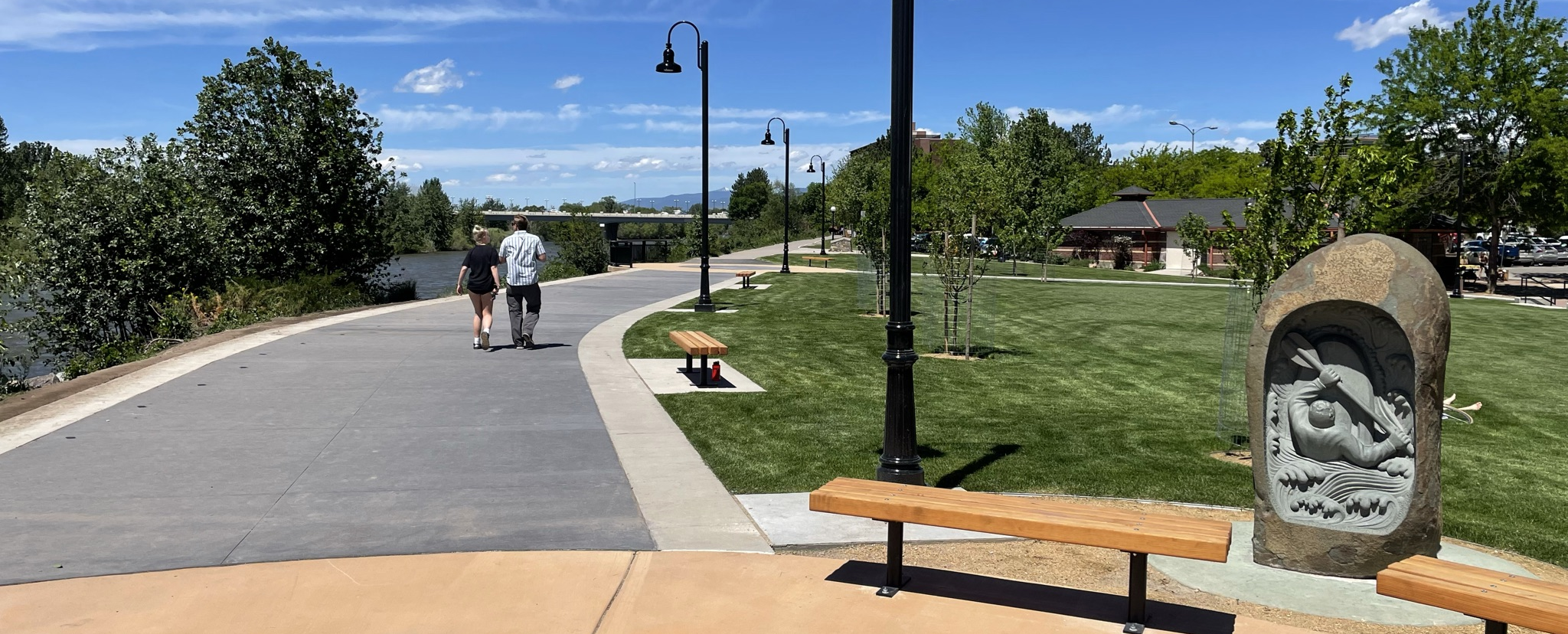 Two people walking on Ron's River Trail in Caras Park