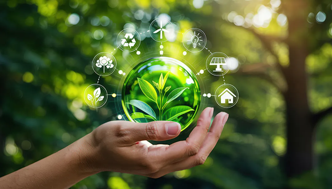 Hand holding orb with sustainability graphics circling 