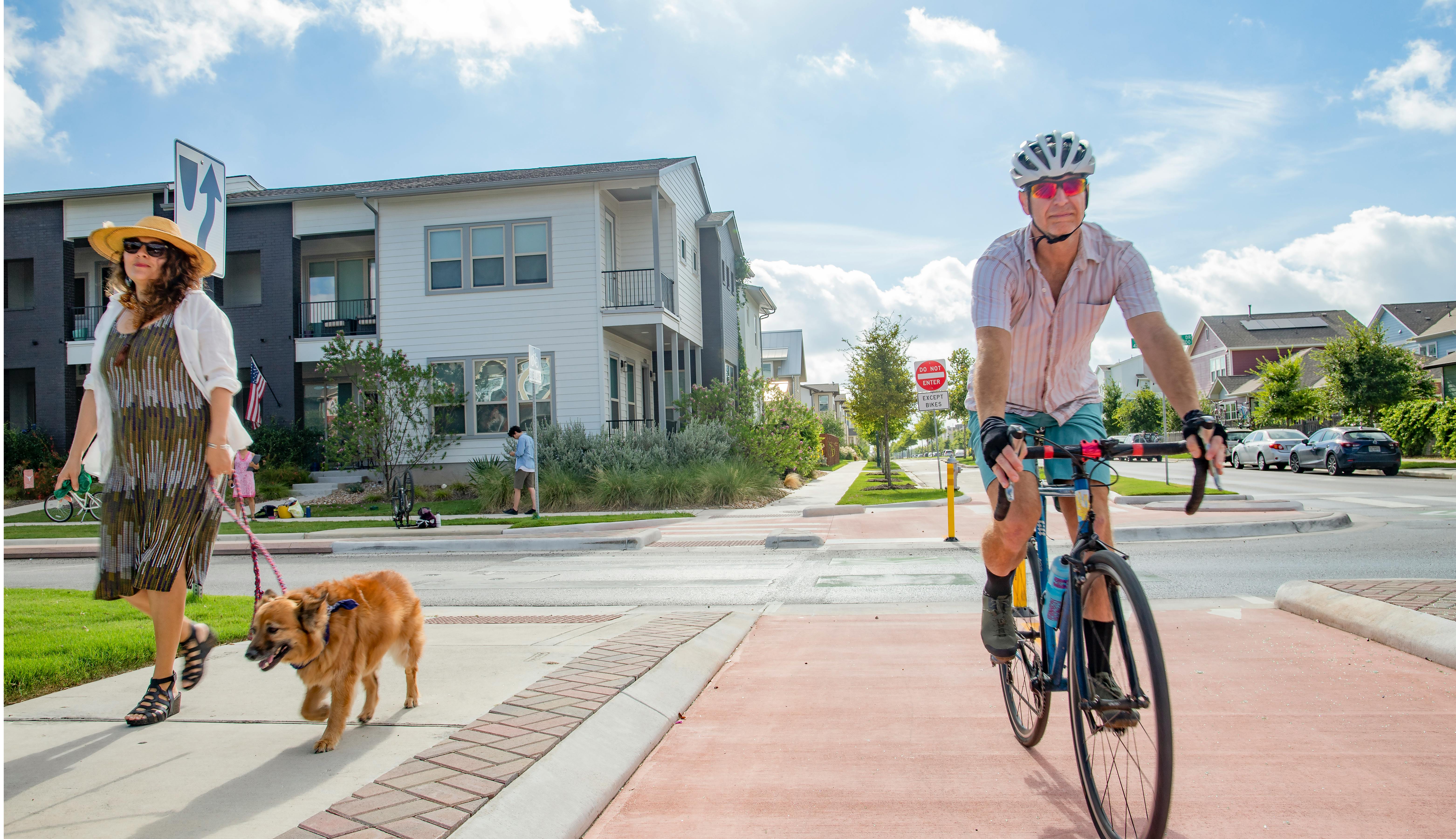 Multi-module transportation example of woman walking dog on walking lane and man riding bicycle on bike lane