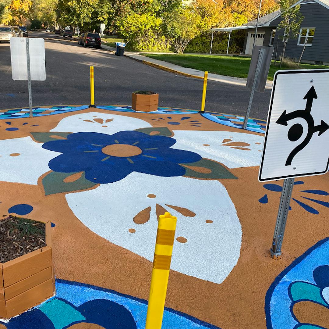 Neighbors painted a flower mandala design in the center of the quick-build traffic circle at the intersection of Maurice Ave. and Hastings St.