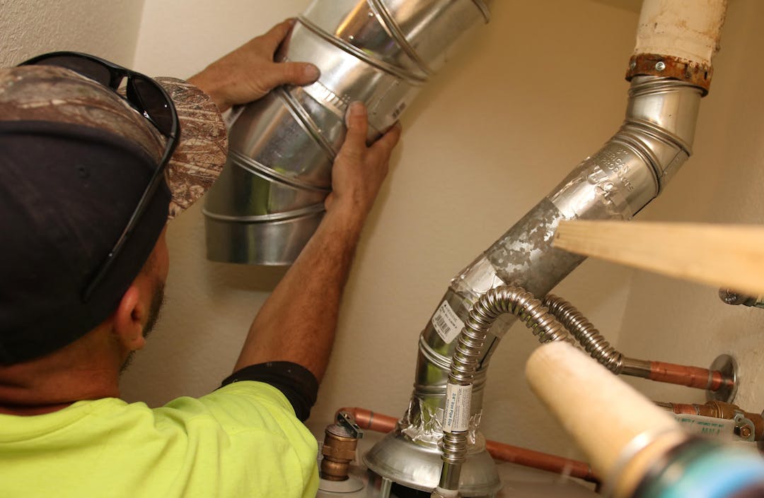 A contractor replaces a water heater as part of the City's Emergency Home Repair Program set to be offered again under the current draft CDBG Annual Action Plan. 