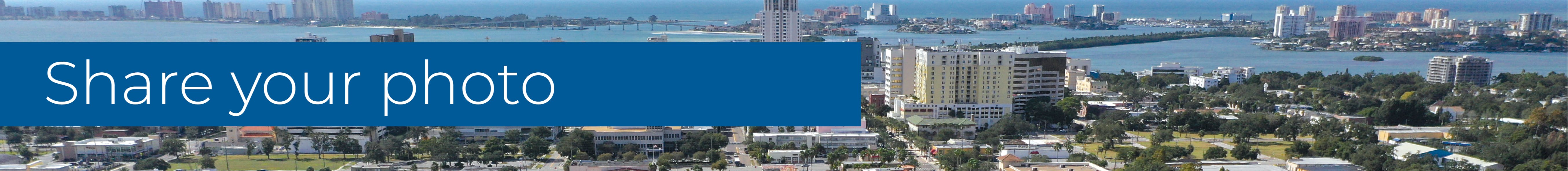 Aerial image of Downtown Clearwater looking west towards the beach and Memorial Causeway. Text over the image says "Share your photo".
