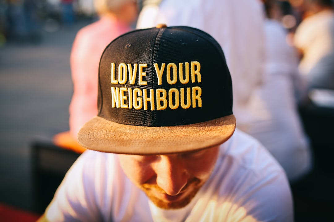 Hat says "Love your neighbor"