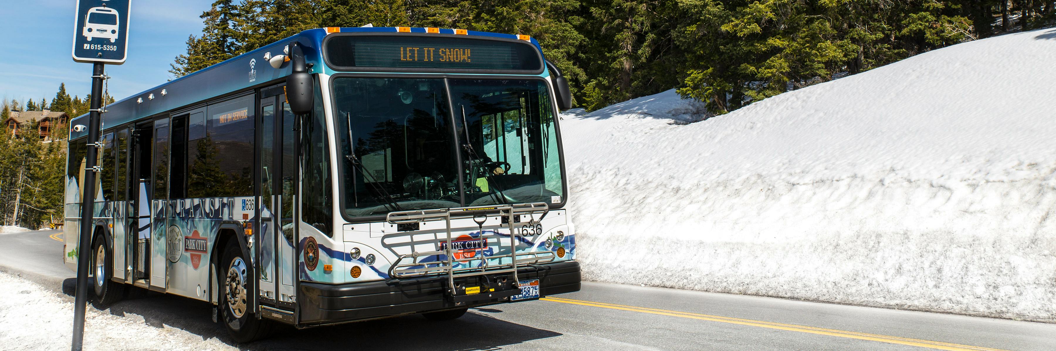 Image depicts a Park City Transit bus driving on state road 224 in the springtime.