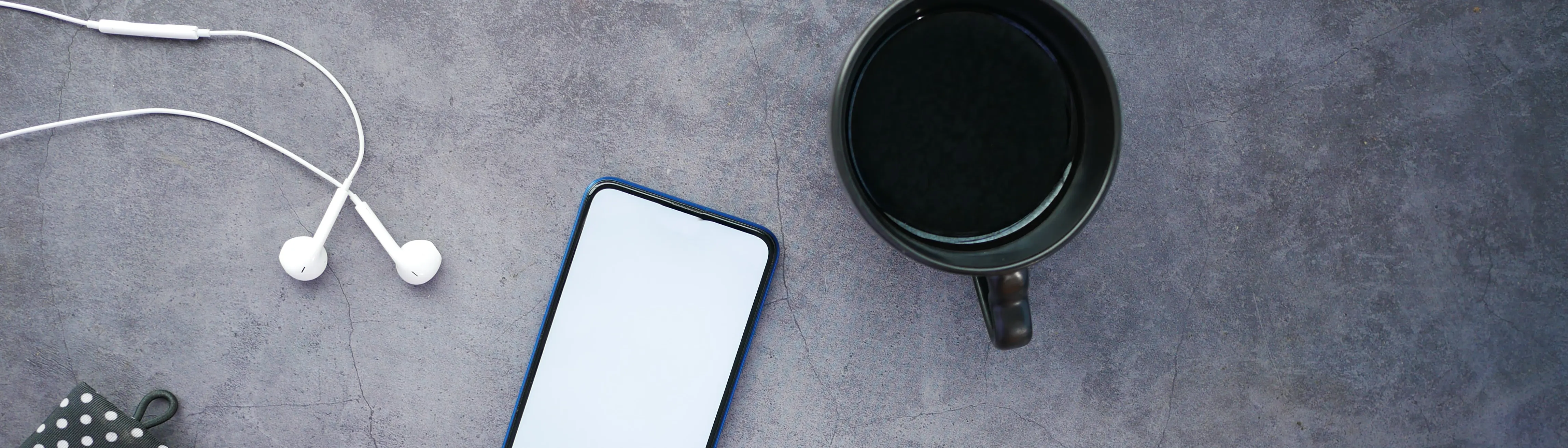 Coffee mug and laptop screen with virtual meeting participants