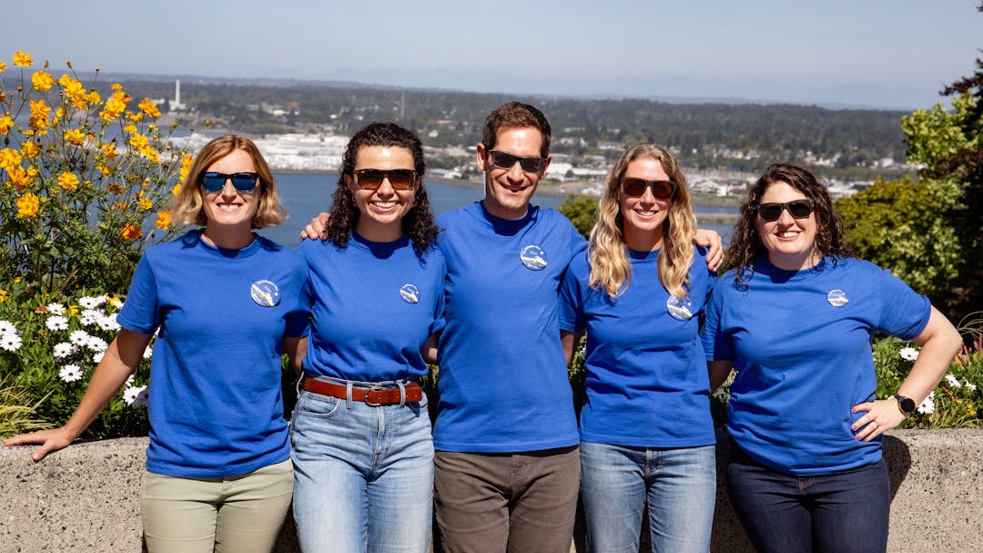 The Bellingham Plan team smiling side by side in sunglasses.