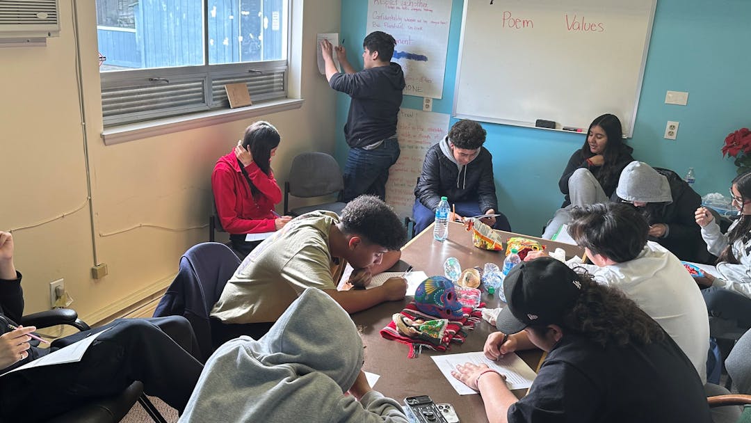 Youth working at a table during a Fresh start program.